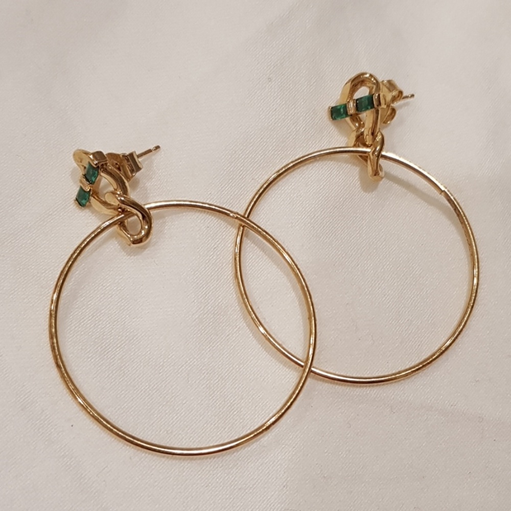 Golden hoop earrings with green accent